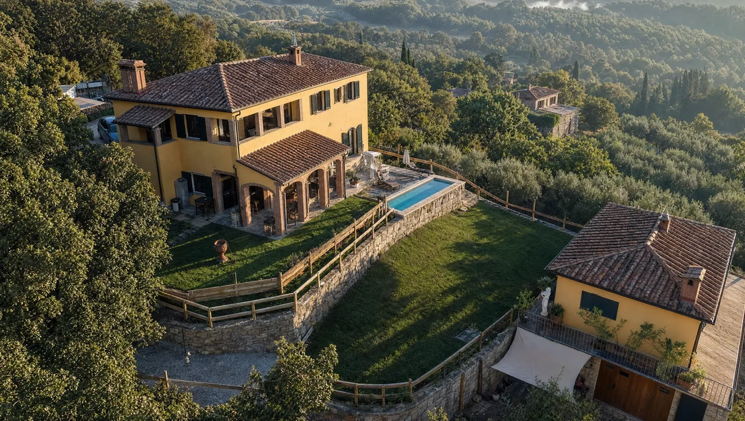 Villa Dolce Vita and its pool from above in the golden Tuscan light