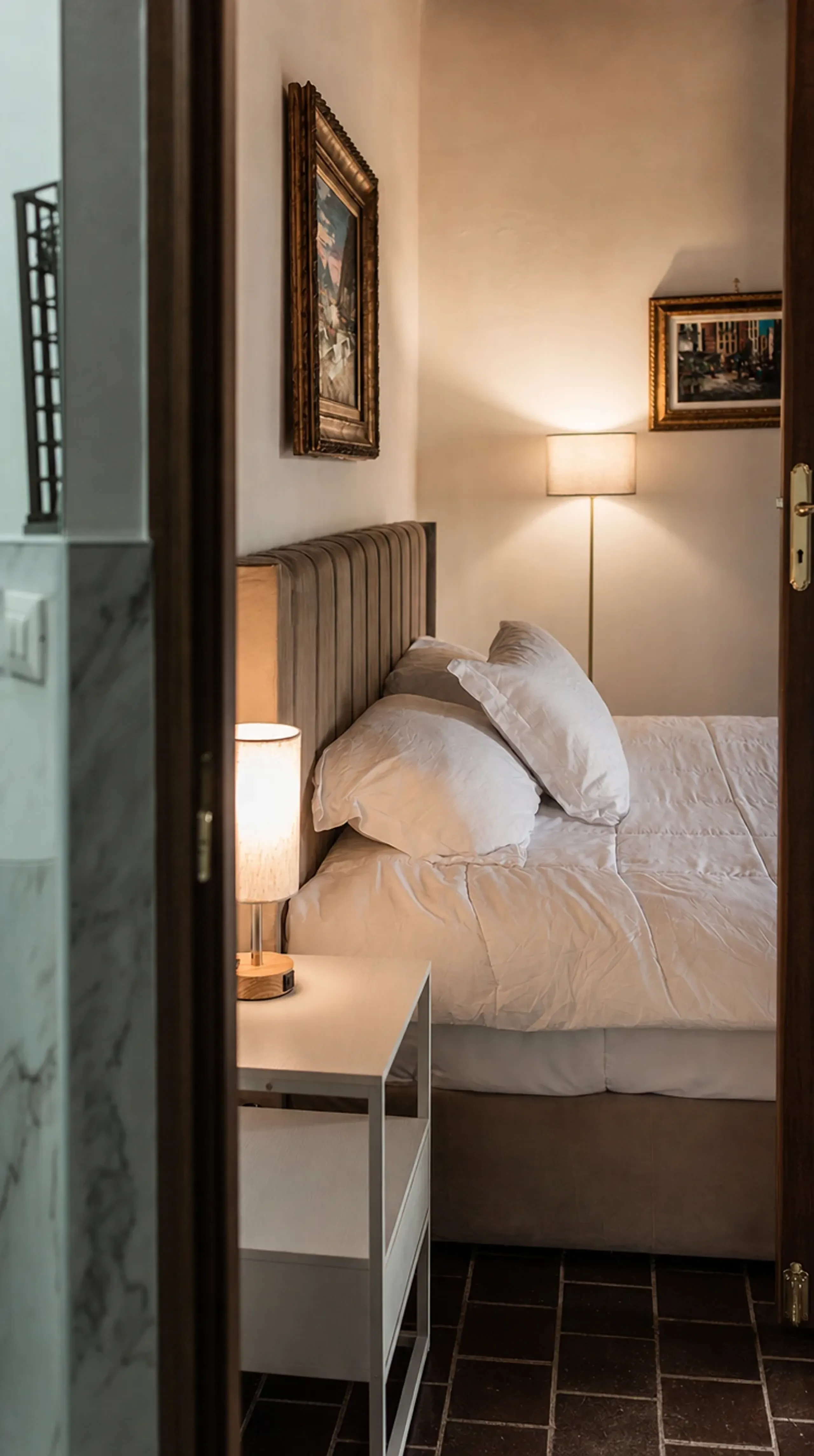 A cozy bedroom in warm lamplight