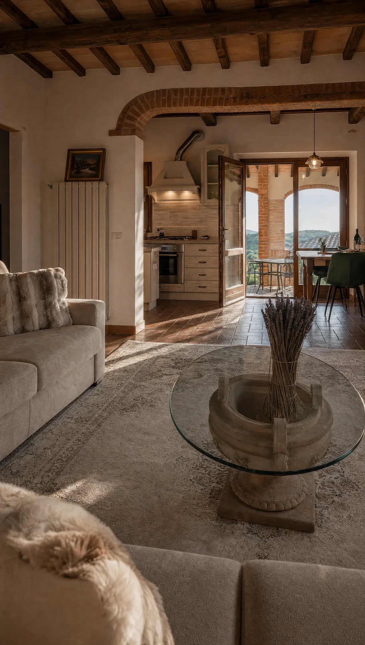 The villa's living room with a glass table and dried lavender, the valley beyond