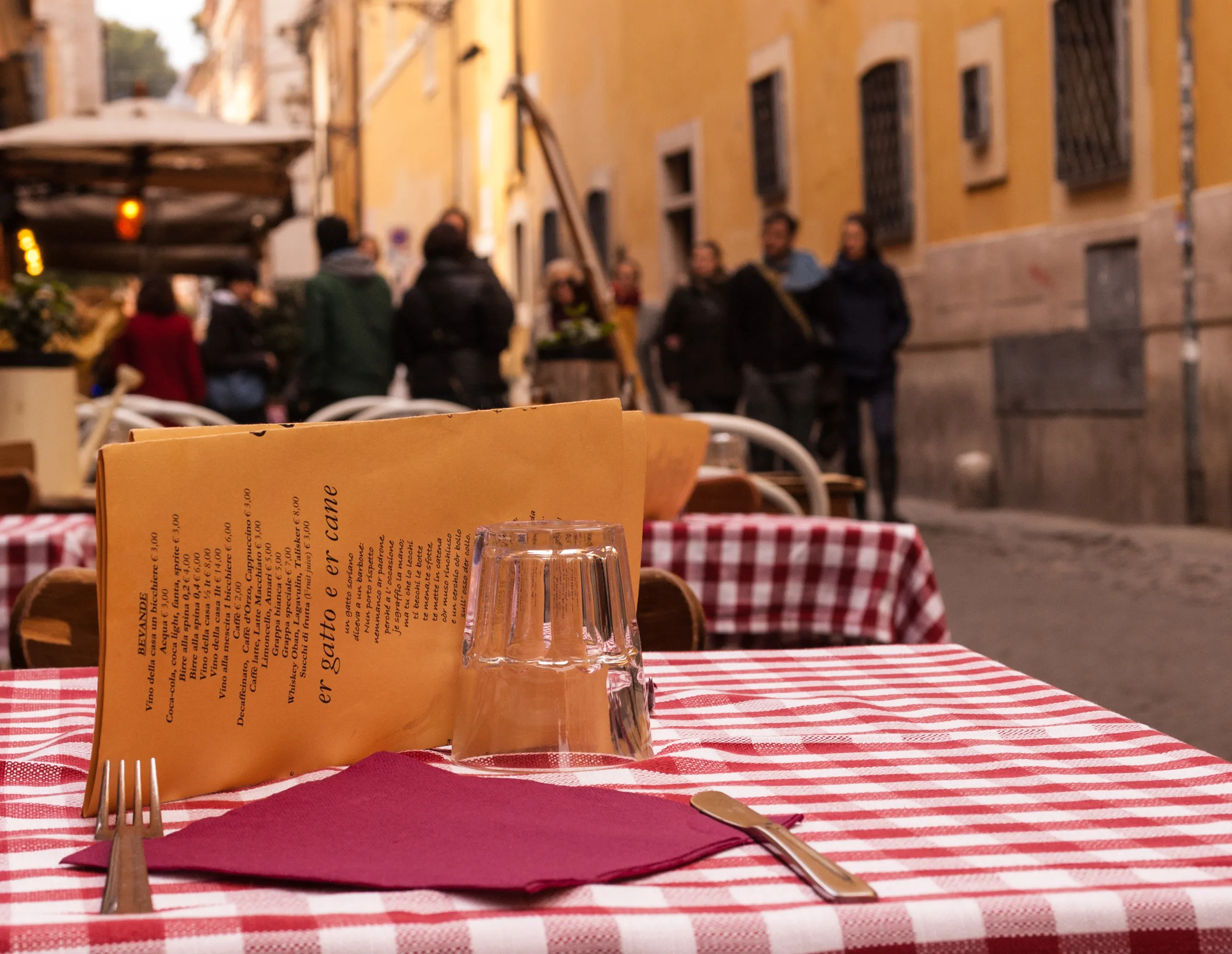 A small osteria table in a narrow medieval alley